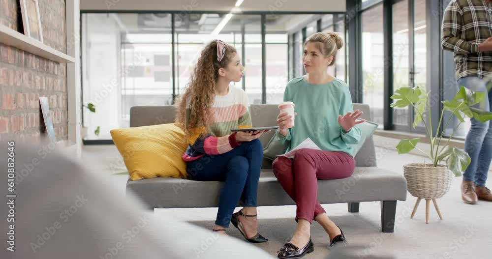 Busy diverse businesswomen talking with takeaway coffee in office in slow motion Busy diverse businesswomen talking with takeaway coffee in office in slow motion