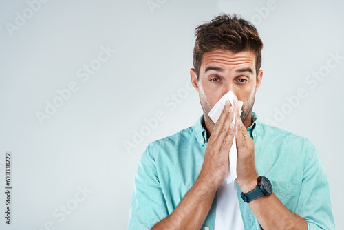 Wipe nose, tissue and portrait of man in studio with flu allergy, sickness and virus on white background. Handkerchief, mockup space and face of male person for hayfever, cold and sneeze for sinus photo