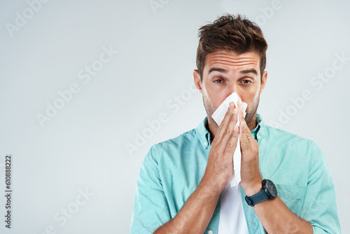 Tablou pe pânză Wipe nose, tissue and portrait of man in studio with flu allergy, sickness and virus on white background