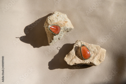 Silver earrings natural sunstone gemstone over  background.