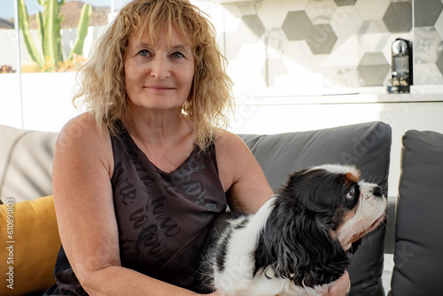 Obraz na płótnie Portrait of cute dog cavalier king charles spaniel sitting at home with his fema