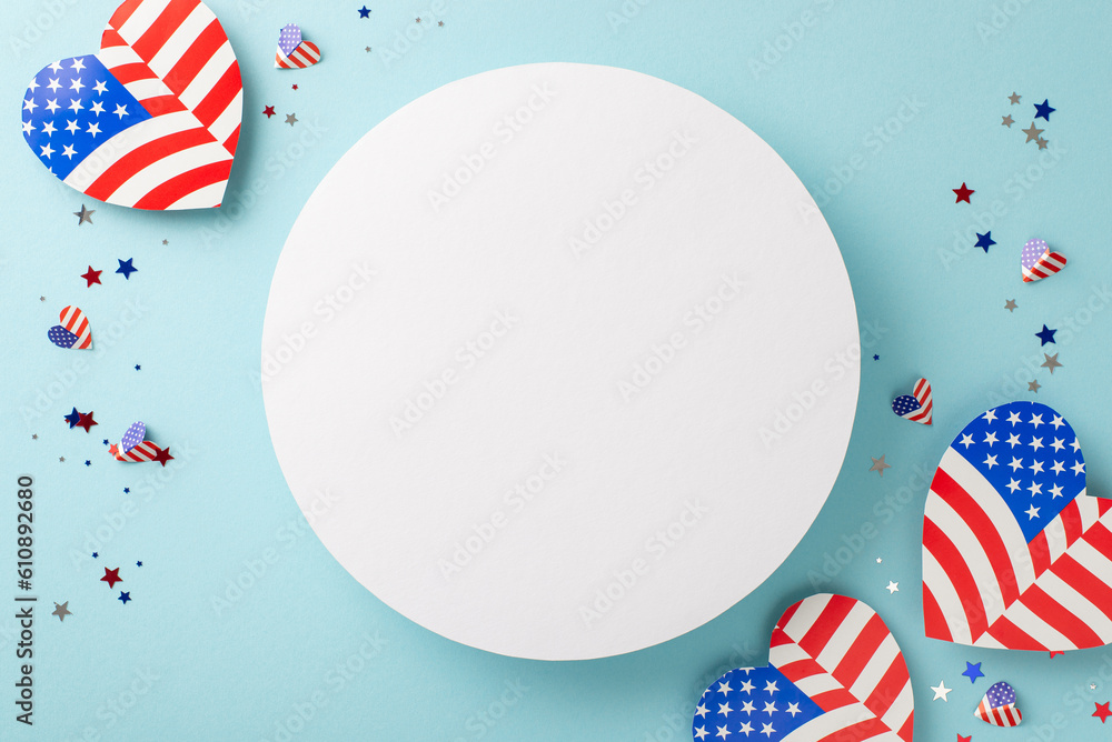 Obraz premium USA Independence Day revelries. Top view of iconic embellishments: hearts featuring national flag motif, confetti, arranged on light blue surface with empty circle perfect for text or promo content