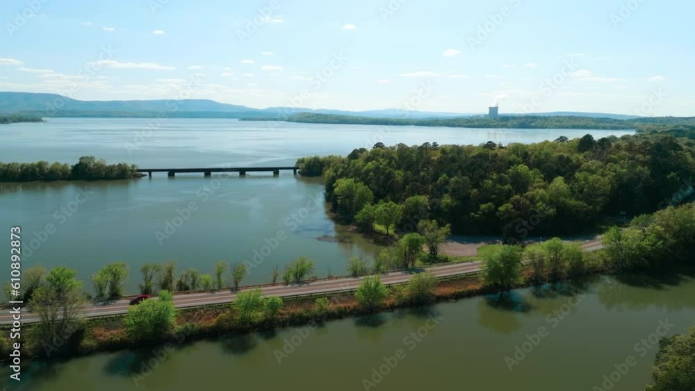 Traffic On The Road With View Of Bridge And Arkansas Nuclear One On Lake Dardanelle In Arkansas, USA. aerial ascend Traffic On The Road With View Of Bridge And Arkansas Nuclear One On Lake Dardanelle In Arkansas, USA. aerial ascend