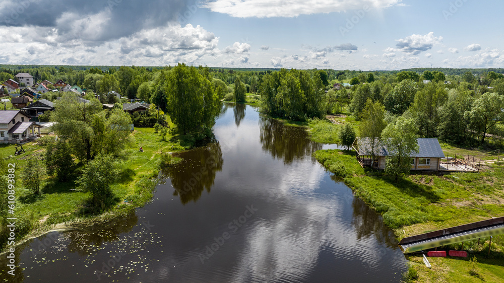 panoramic view of the river and coastal forest and houses on a summer day shot from a drone panoramic view of the river and coastal forest and houses on a summer day shot from a drone