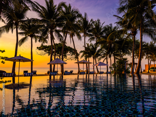 Beachfront sunrise with pool and palm trees in Hua Hin, Prachuap Khiri Khan, Thailand © pierrick