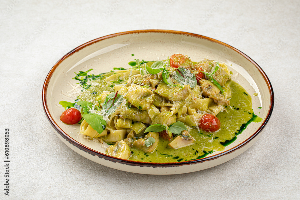 Portion of gourmet pasta fettuccine with pesto sauce Portion of gourmet pasta fettuccine with pesto sauce