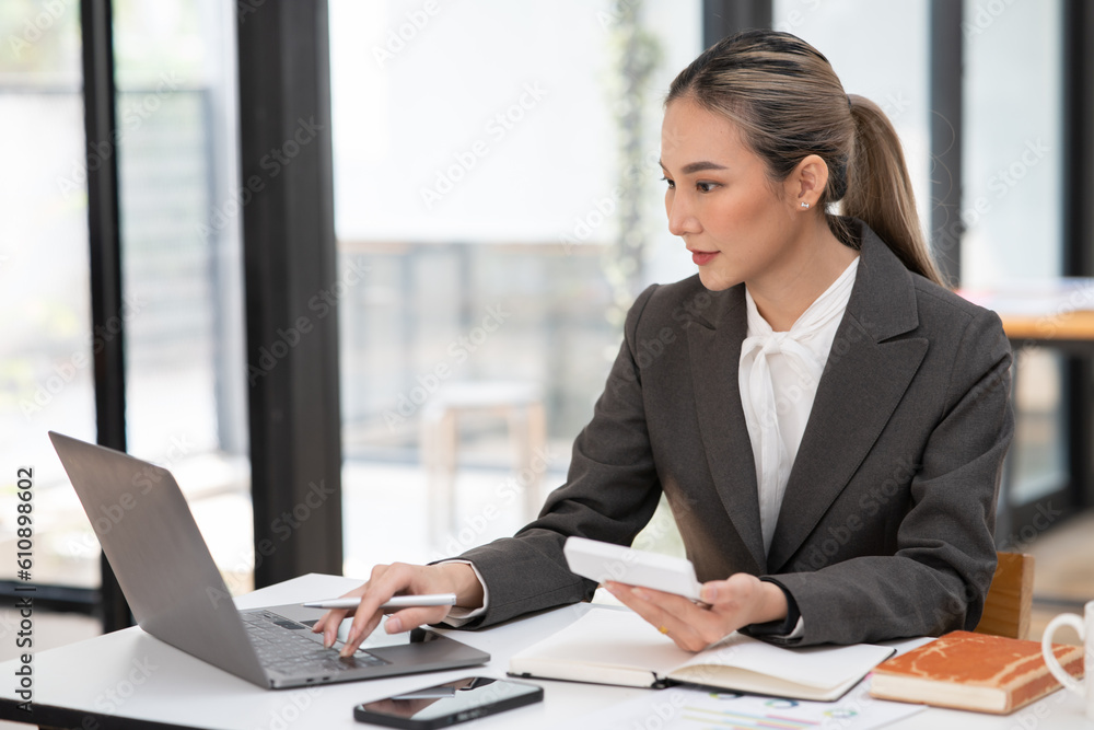 Asian businesswoman working on documents at office Asian businesswoman working on documents at office