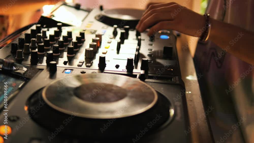 Professional DJ playing electronic music, male hands mixing and scratching at night club party 4K close up footage. Professional DJ playing electronic music, male hands mixing and scratching at night club party 4K close up footage.