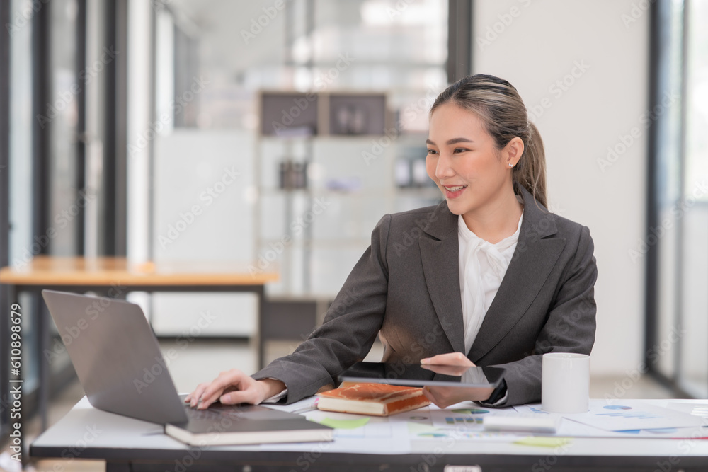Asian businesswoman working on documents at office Asian businesswoman working on documents at office