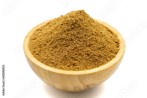 Coriander powder isolated on white background. Powdered dried Coriander in wooden bowl. Close up