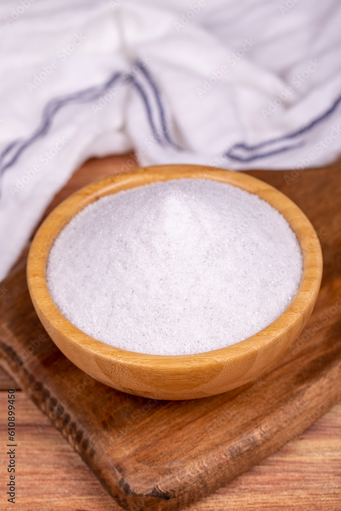 Natural minaret crystal non-iodized grinding salt on wooden background. Ground rock salt in wooden bowl Natural minaret crystal non-iodized grinding salt on wooden background. Ground rock salt in wooden bowl