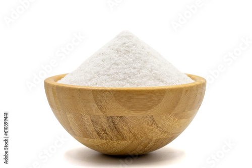 Natural minaret crystal non-iodized grinding salt isolated on white background. Ground rock salt in wooden bowl