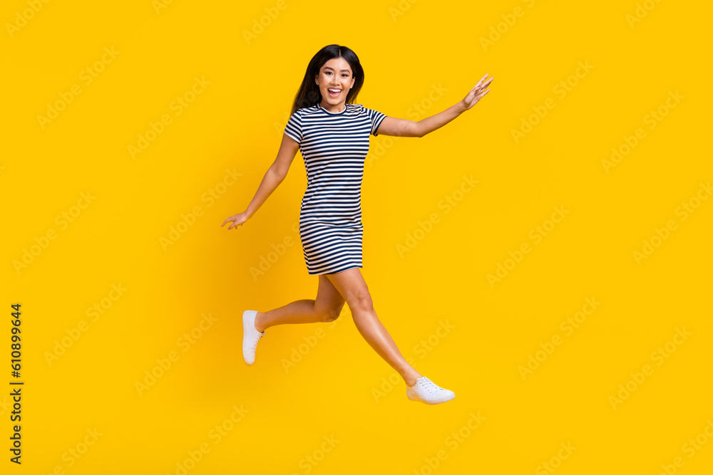Full length size photo of funky jump careless lightness running hurry girl fast speed trendy outfit isolated on yellow color background Full length size photo of funky jump careless lightness running hurry girl fast speed trendy outfit isolated on yellow color background