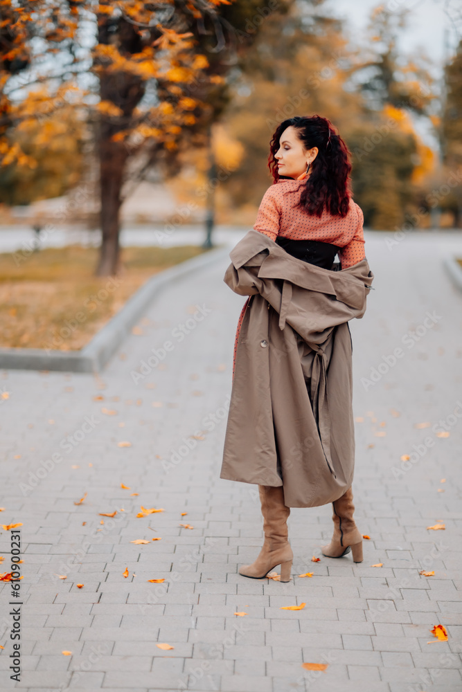 A woman walks outdoors in autumn, enjoys the autumn weather. A woman walks outdoors in autumn, enjoys the autumn weather.