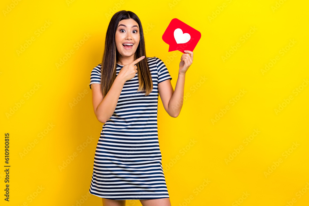 Photo of adorable excited woman dressed striped outfit pointing finger feedback card empty space isolated yellow color background Photo of adorable excited woman dressed striped outfit pointing finger feedback card empty space isolated yellow color background