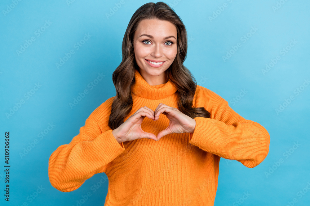 Portrait of cute stylish lady showing heart symbol sign hands donation wear orange pullover isolated blue color background