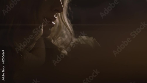 Close up view of romantic woman sitting in the car holding white rose, tender slim hands, light flashes. Being in love, dreaming and waiting for a date. Blond female portrait. High quality 4k footage