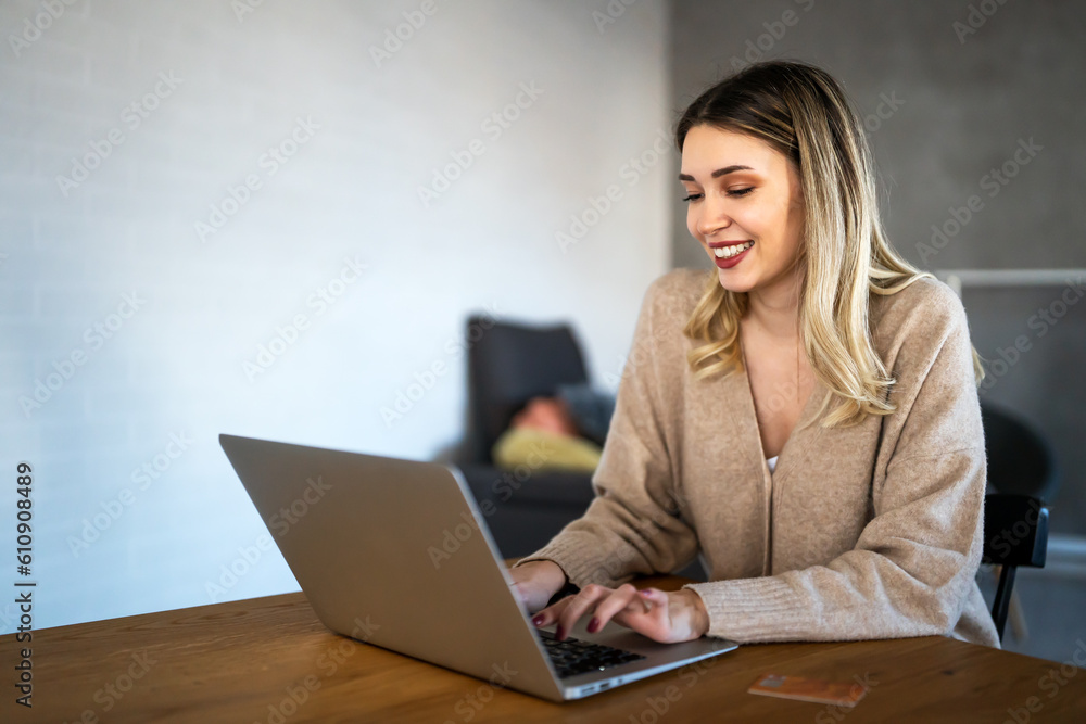 Smiling pretty woman using laptop for work freelance social media or relaxation. Smiling pretty woman using laptop for work freelance social media or relaxation.