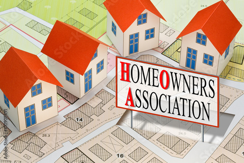 Homeowner Association concept with residential homes models against an imaginary city map and text photo