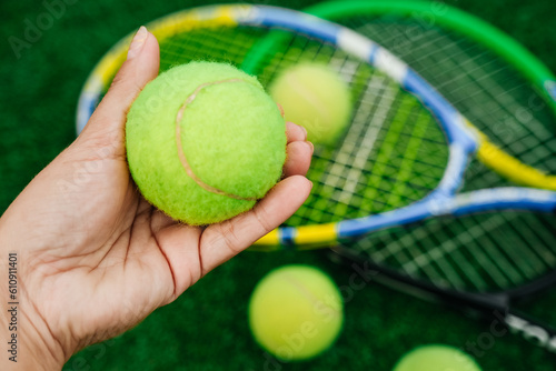 Tennis rackets and tennis balls. Tennis equipment on the tennis court. Sports, tennis and a green court. © Guzalia