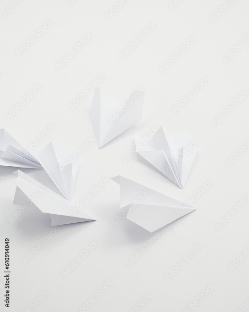 White paper airplanes on a white background. White paper airplanes on a white background.