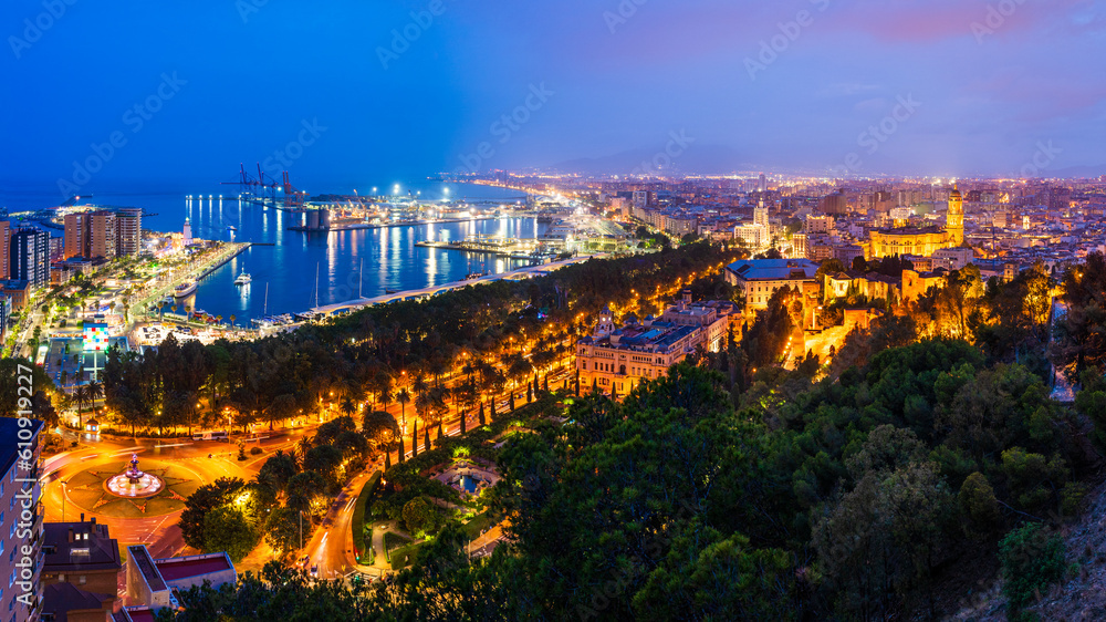 Malaga, Andalusia, Spain: Panoramic aerial view of Malaga coastline, Malaga Cathedral, the old town, port and Malaga Marina at twilight
