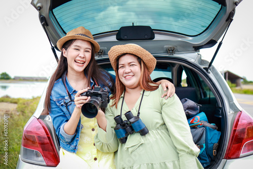 Portrait of two Asian women traveling by private car. Transport concept, tourism. Asian tourists © SUPERMAO