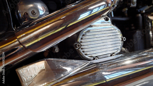 Glossy shiny polished exhaust pipes on vintage bike. Retro motorcycle detail