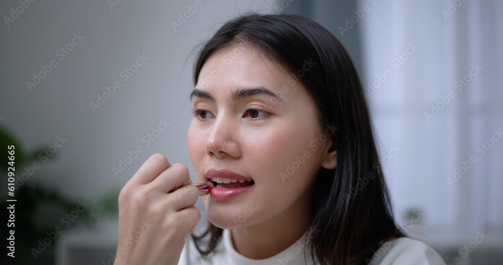 Beautiful young Asian woman blogger shows how to make up and use cosmetics