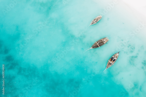 Top view or aerial view of Beautiful crystal clear water and white beach with long tail boats in summer of Zanzibar island