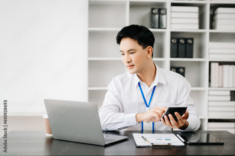 Man freelancer is working her job on computer tablet and laptop Doing accounting analysis report real estate investment data, Financial at office Man freelancer is working her job on computer tablet and laptop Doing accounting analysis report real estate investment data, Financial at office