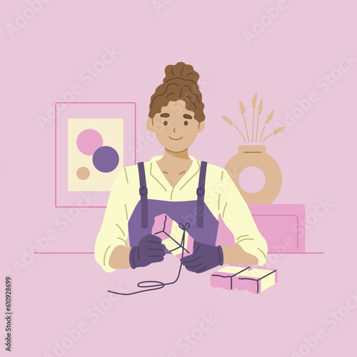 Female soap maker holds handmade soap in her hands.