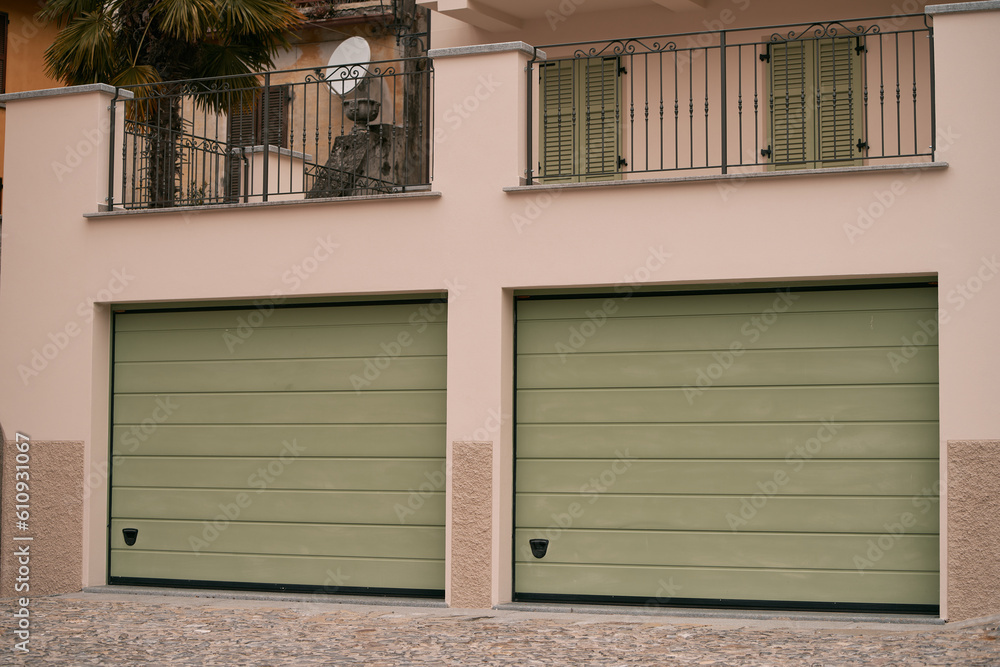 Garage concept. Closed garage doors. Exterior view of a beautiful house with garage gate. Garage concept. Closed garage doors. Exterior view of a beautiful house with garage gate.