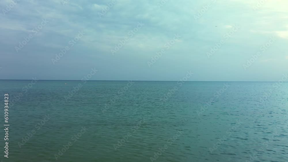 a quick flight over the water surface of the sea . calm water surface at dawn. a quick flight over the water surface of the sea . calm water surface at dawn.