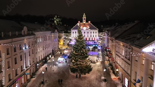  Christmas Market, aerial view. Illuminated Christmas fair in a modern city. Night time aerial footage with a drone showing the Christmas Market and Christmas tree. 