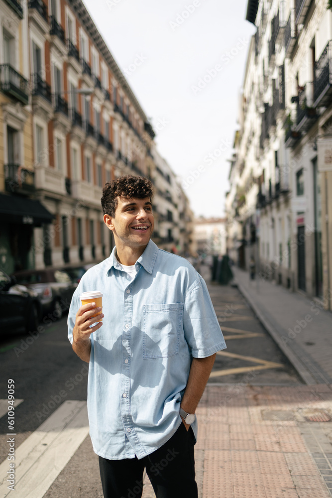 Young man in the street with cup of coffee