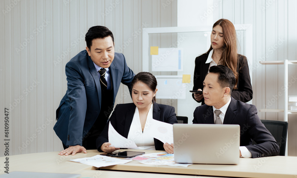 Business mentor meeting with team in office looking at computer screen training management concept. Asian businessman work together with executive colleague group talking mentoring leadership idea. Business mentor meeting with team in office looking at computer screen training management concept. Asian businessman work together with executive colleague group talking mentoring leadership idea.