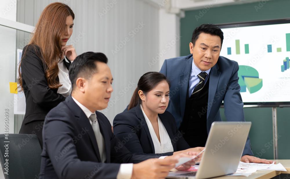 Business mentor meeting with team in office looking at computer screen training management concept. Asian businessman work together with executive colleague group talking mentoring leadership idea. Business mentor meeting with team in office looking at computer screen training management concept. Asian businessman work together with executive colleague group talking mentoring leadership idea.