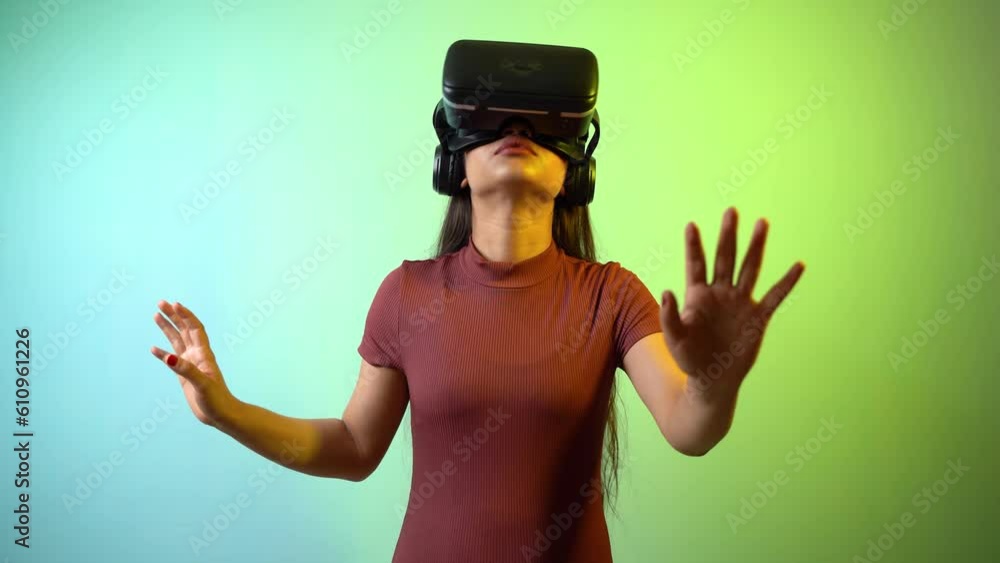 Young Asian Indian woman wearing virtual reality headset, a girl with VR glasses concept studio portrait Young Asian Indian woman wearing virtual reality headset, a girl with VR glasses concept studio portrait