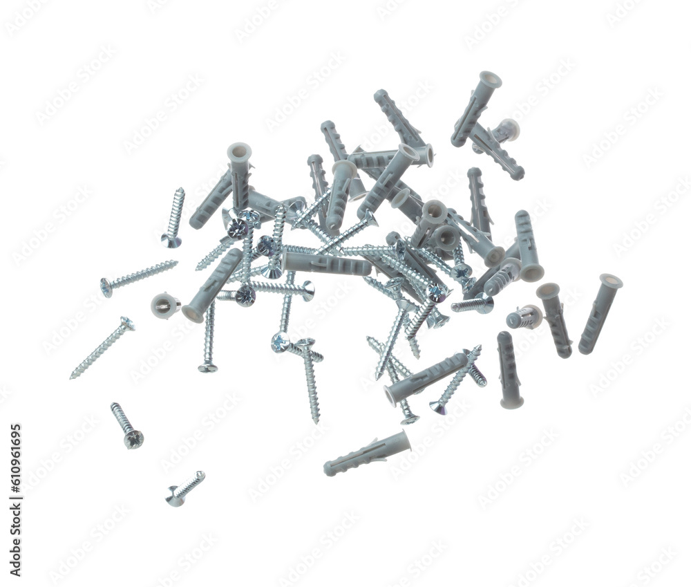 Flying Plastic gray dowel and screw in air. Expansion anchors, fixing dowel with chromed screw