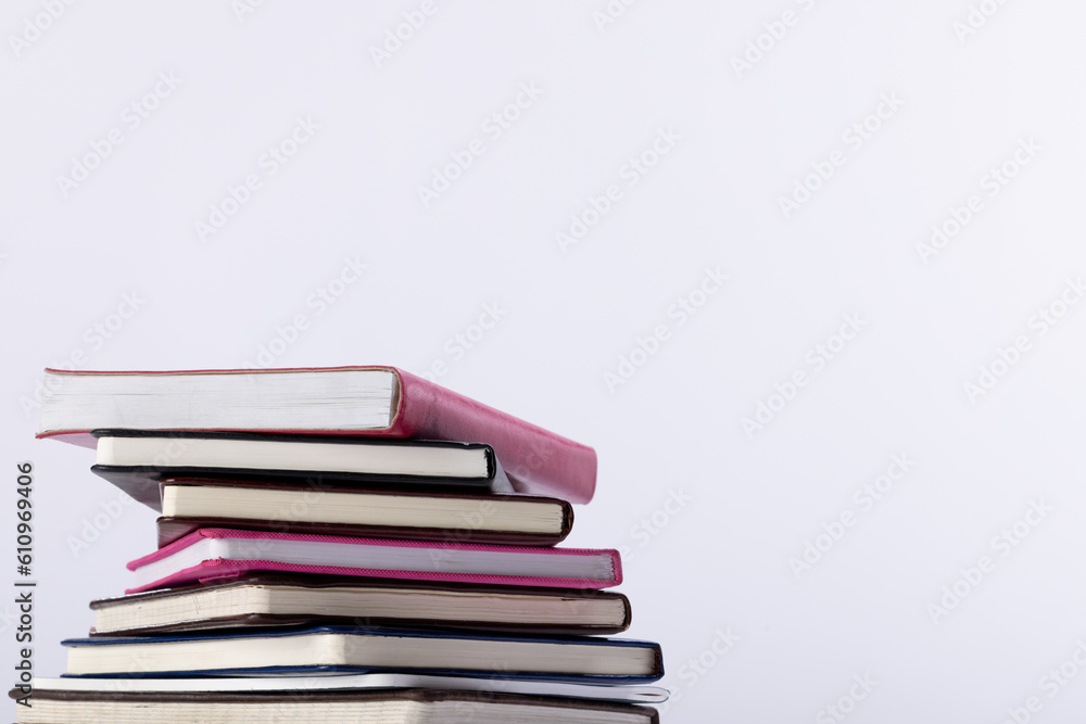 Obraz premium Close up of stack of books and notebooks with copy space on white background