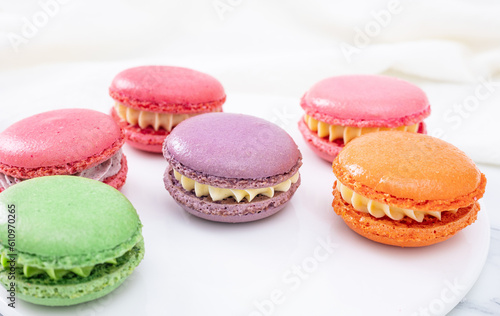 Colorful macaron cakes with cream filling on a table indoors, close-up