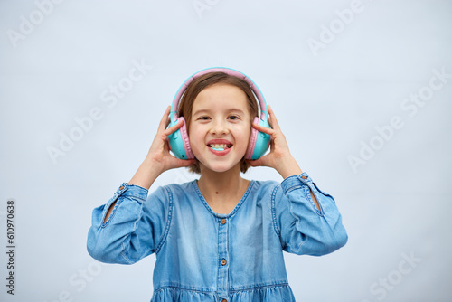 Girl teenagerwith chewing gum listening to music in headphones photo