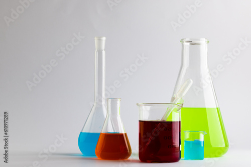 Close up of chemistry test tubes and dishes with copy space on white background