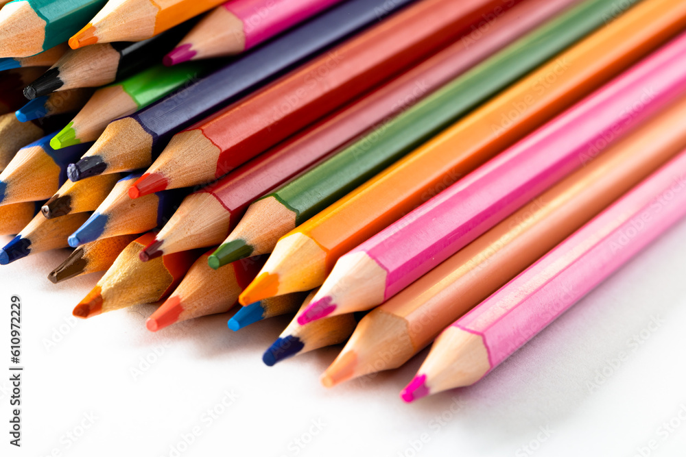 Close up of multi coloured pencils and copy space on white background Close up of multi coloured pencils and copy space on white background