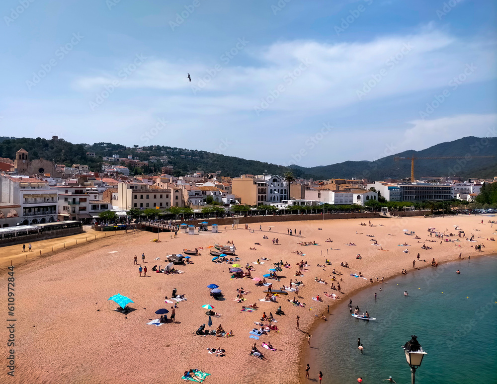 Central beach of Tossa de Mar with unrecognizable bathers, seen from the Vila Vella de Tossa (aerial view)