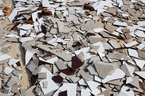 Gypsum scrap and tile debris on the floor
