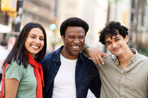 Portrait of smiling multiracial student standing together on the street, education concept. Happy successful business people, colleagues, workers looking at camera, selective focus