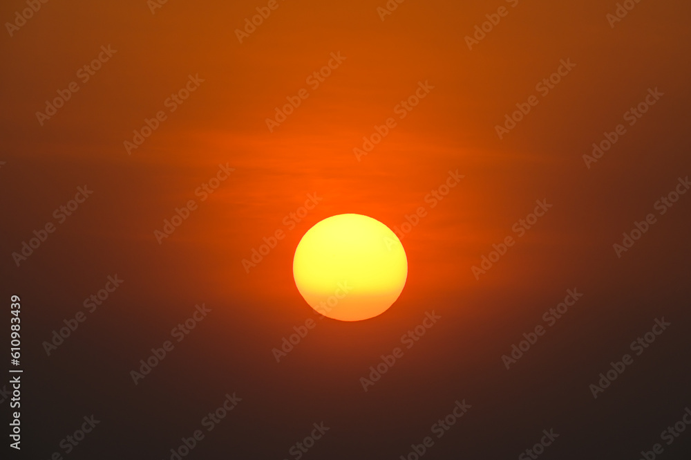 big orange sun on sunset background