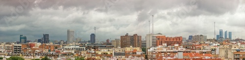 Madrid, Spain; 06-07-2023: Panoramic view of Madrid from behind the Paseo de la Castellana with its most emblematic buildings such as the famous towers , the Kio towers and others on a rainy day